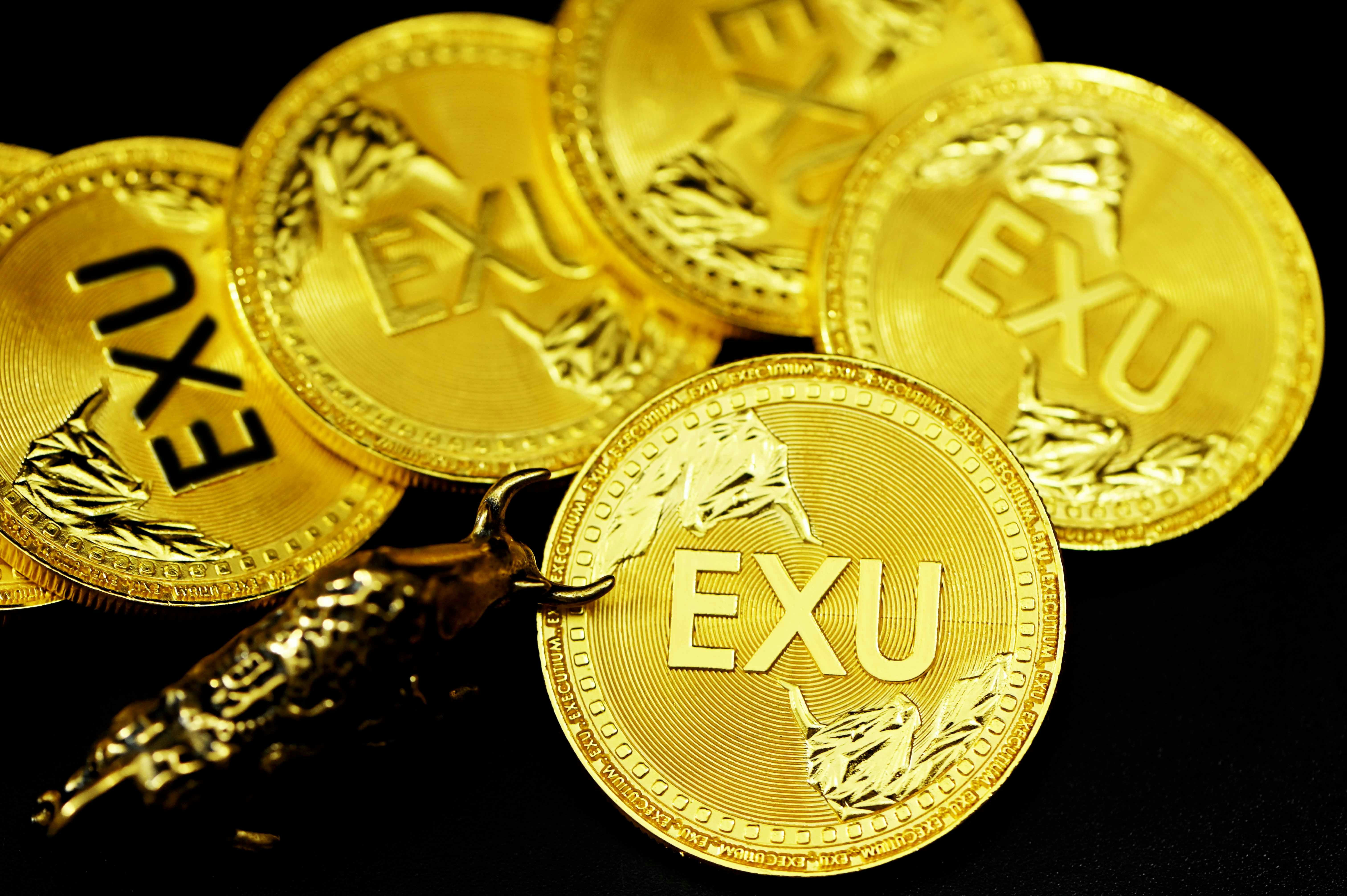 A group of EXU coins with a bull